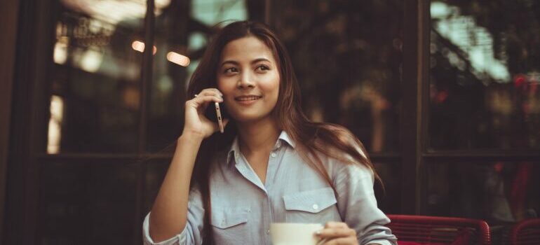A woman making a call to find storage solutions Austin offers.