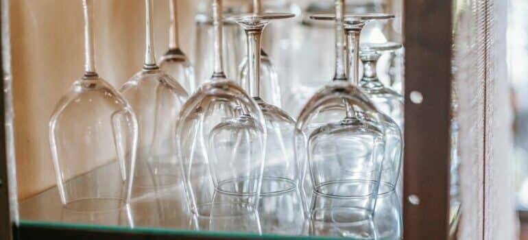 Clean glassware arranged upside down on a glass shelf.