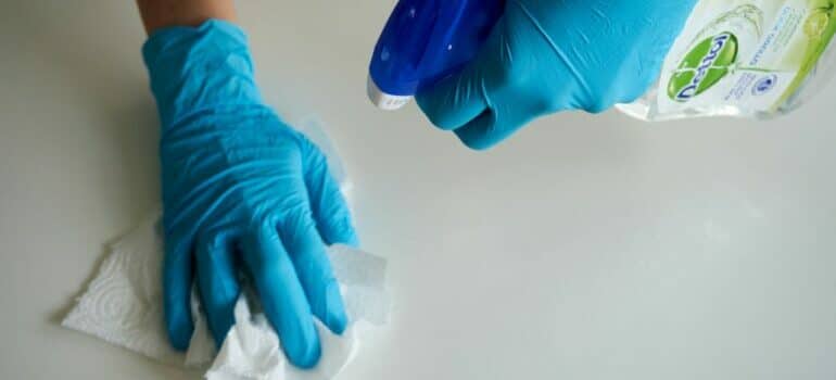 person with gloves cleaning