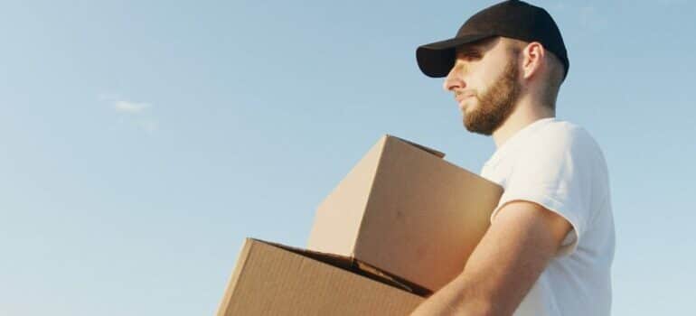 A man carrying two boxes