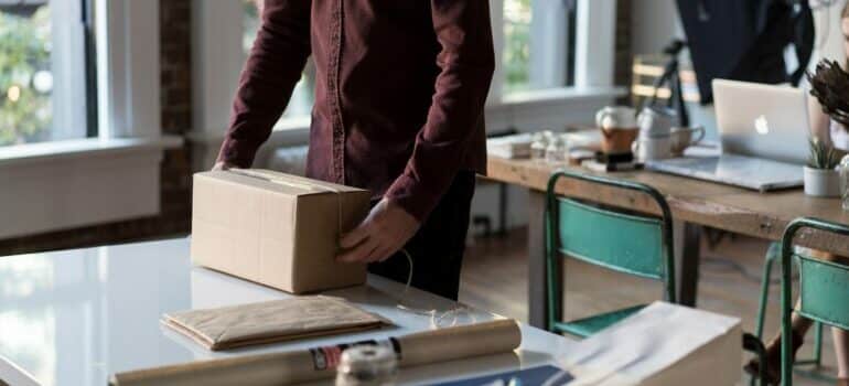 woman in red dress wrapping the package.