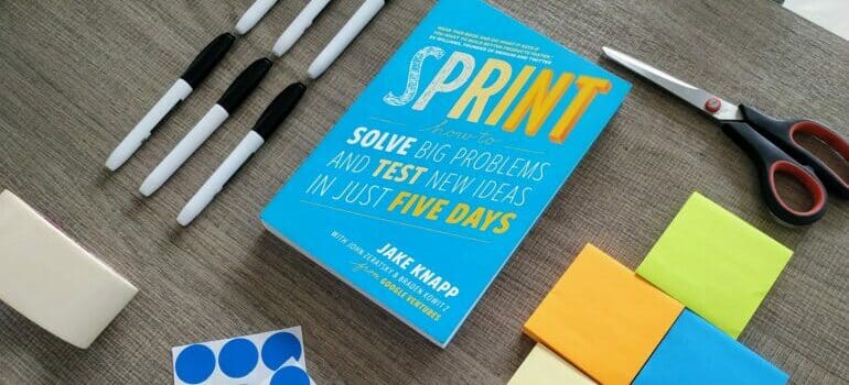 sticky notes and scissors on brown table