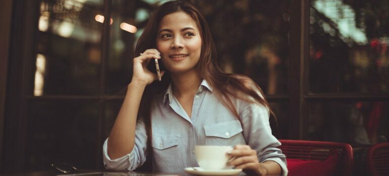 A woman making a phone call to movers Circle C.