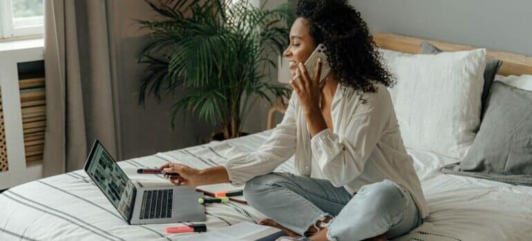 a woman contacting the most reliable movers Northwest Hills can offer