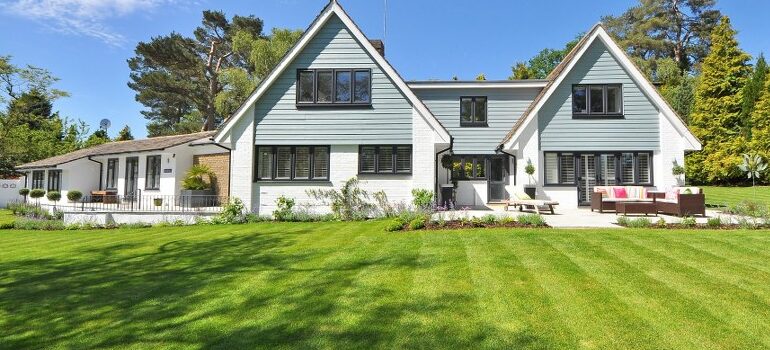 a nice white house, front view, huge lawn