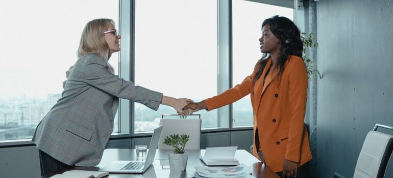 two women, office meeting, handshake