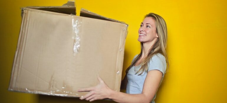 woman holding an old cardboard box