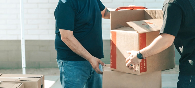 movers carrying boxes to storage North Austin