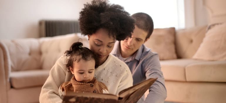 Family reading a book - kid-friendly places in Austin