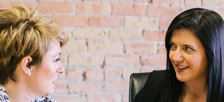 to women at the table talking