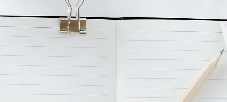 a notebook and a pen on the desk