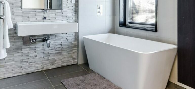 bathroom with gray tile flooring