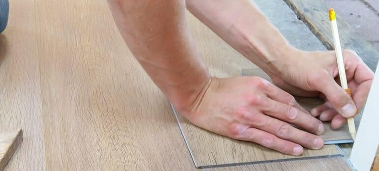 a man measuring the space in his home