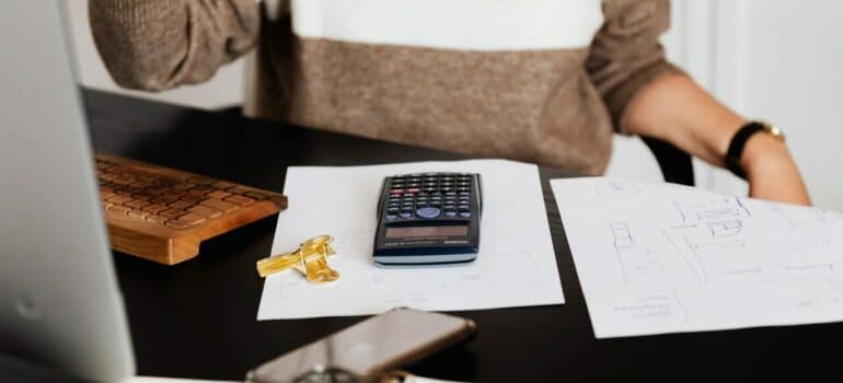 a woman resting after calculating how much money she will spend on moving