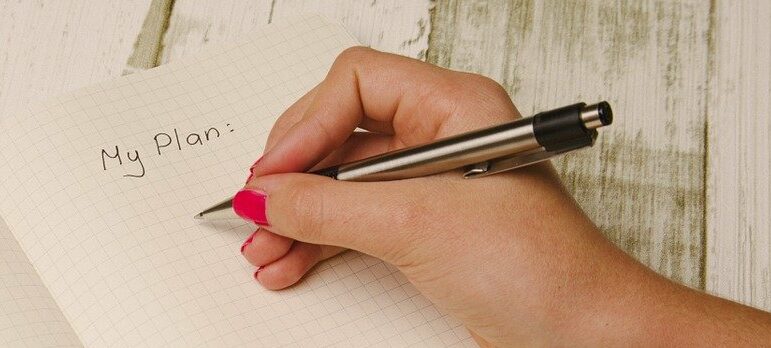 a hand writing on paper