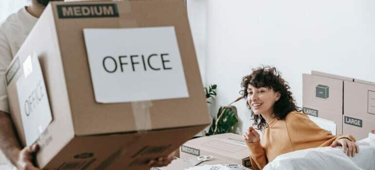 A couple packing their office for relocation in a day