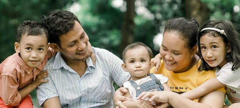 family sitting in the park