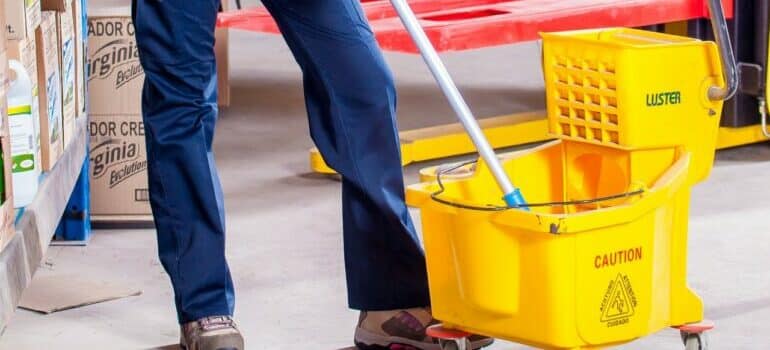 person cleaning storage