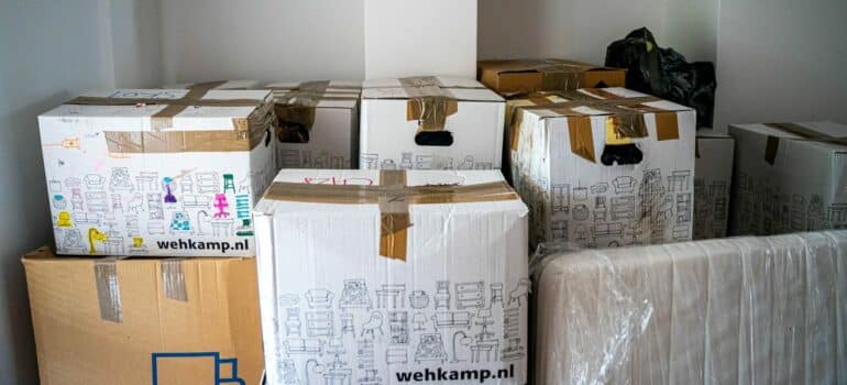 a pile of cardboard boxes inside a storage