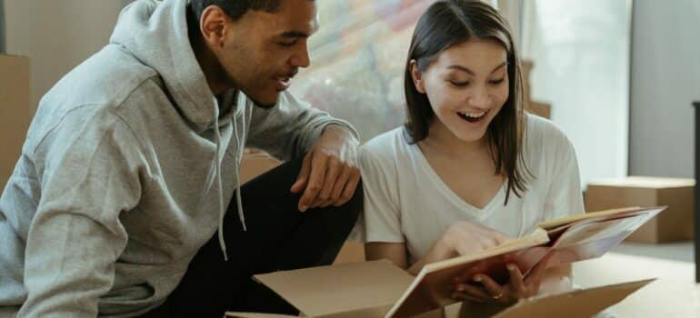 a couple looking at how stay efficient while unpacking