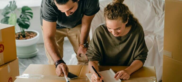 a couple coming up with an inventory list while packing
