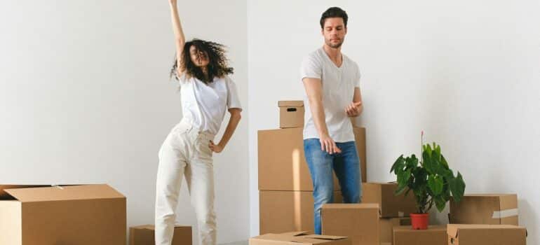 a couple dancing while unpacking