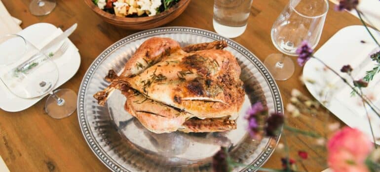 a cooked turkey as the centerpiece of the thanksgiving table