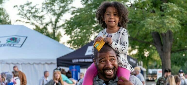 father and daughter at one of Thanksgiving parades in Texas