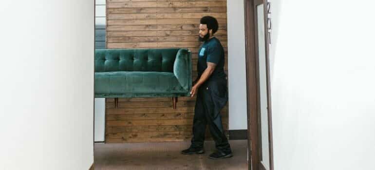 Moving professional carrying sofa