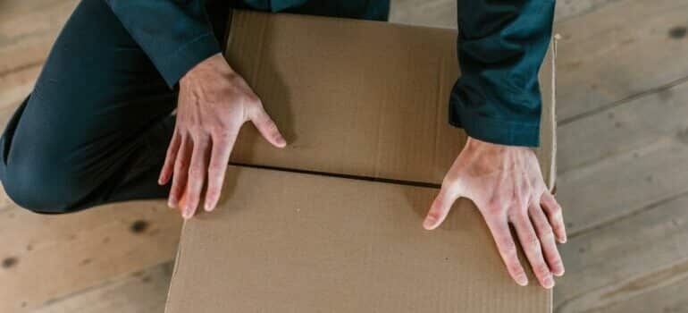 man storing kitchen appliances