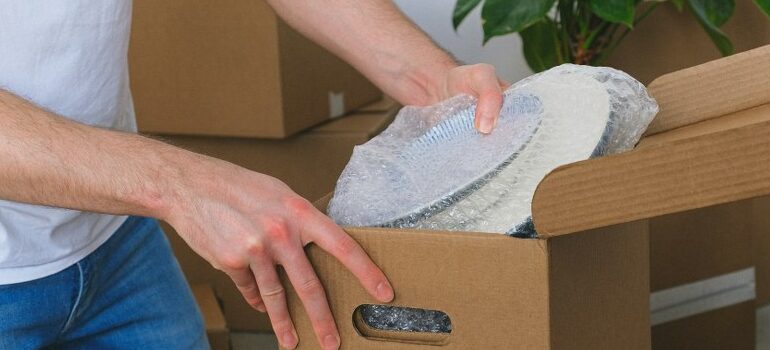 person packing dishes