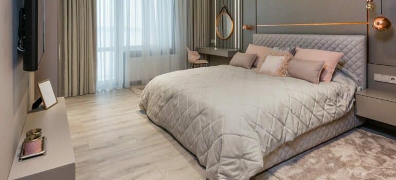 a bedroom with a large bed in it, to represent a place in which you can locate a safe