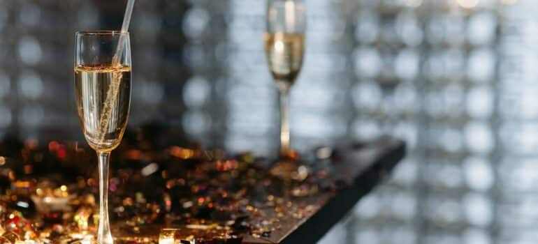 two glasses of liquor on a table filled with confetti