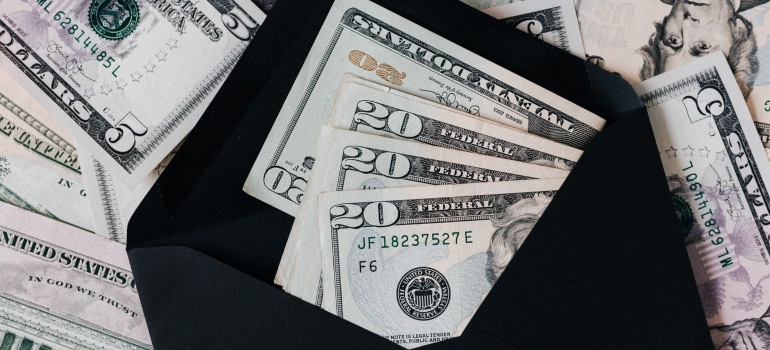 a stash of money in a black envelope