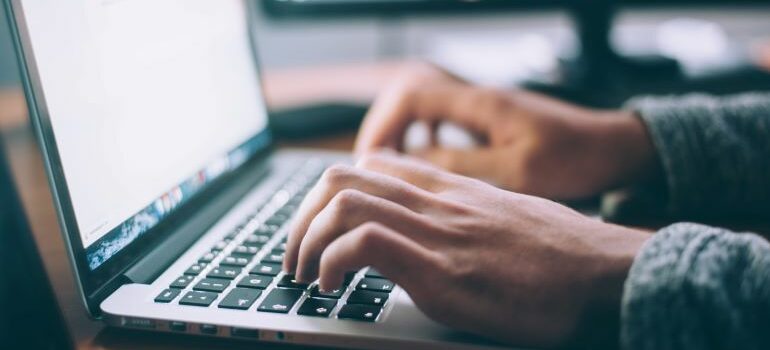 hands typing on a computer