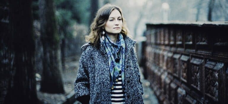 a woman standing in the street in cold weather