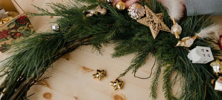 a person holding a christmas wreath