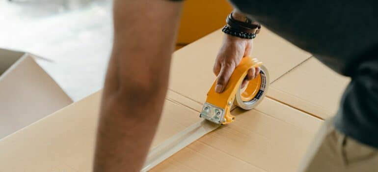 man labeling box to avoid mistakes when storing stuff