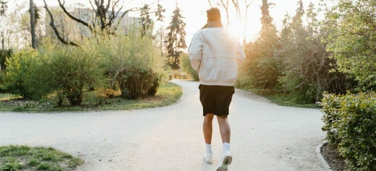 a man running through a park to represent one of the January activities in Austin
