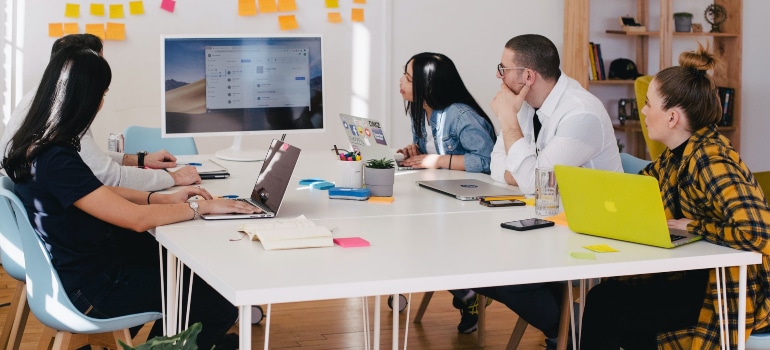 a team of employees carefully watching at the plan for moving offices from Austin