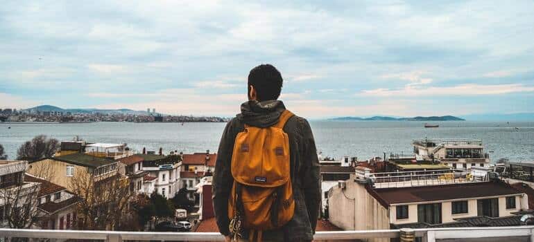 A person looking at the city on a lake