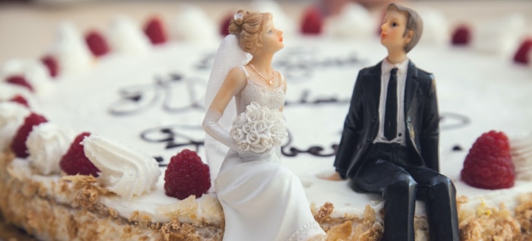 Cake topper of newly weds on top of the cake, ready to be stored as wedding memorabilia