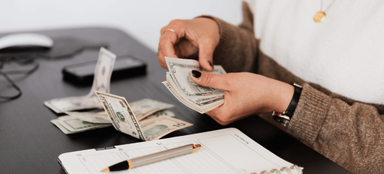 a woman counting dollar bills
