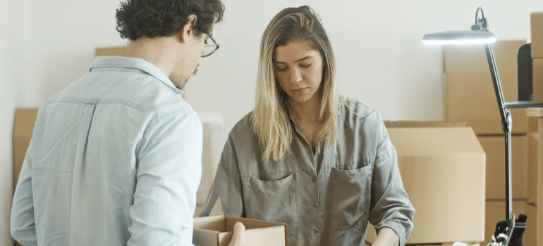 a woman and a man applying office decluttering tips