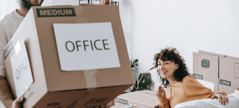 a man carrying cardboard box