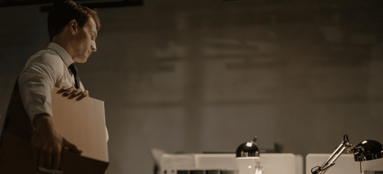 a man carrying a box in the office