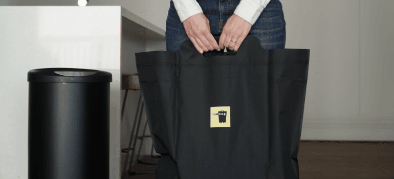 a woman holding a black bag