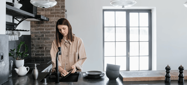 a woman washing dishes