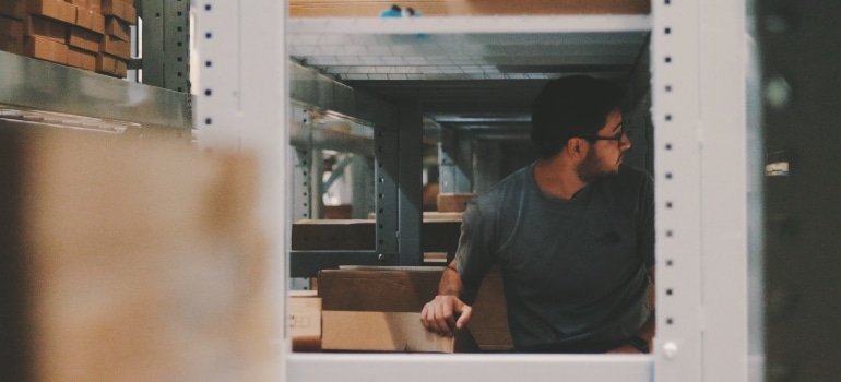 man standing inside a storage unit