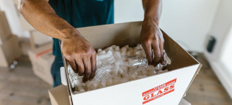 a man packing glassware